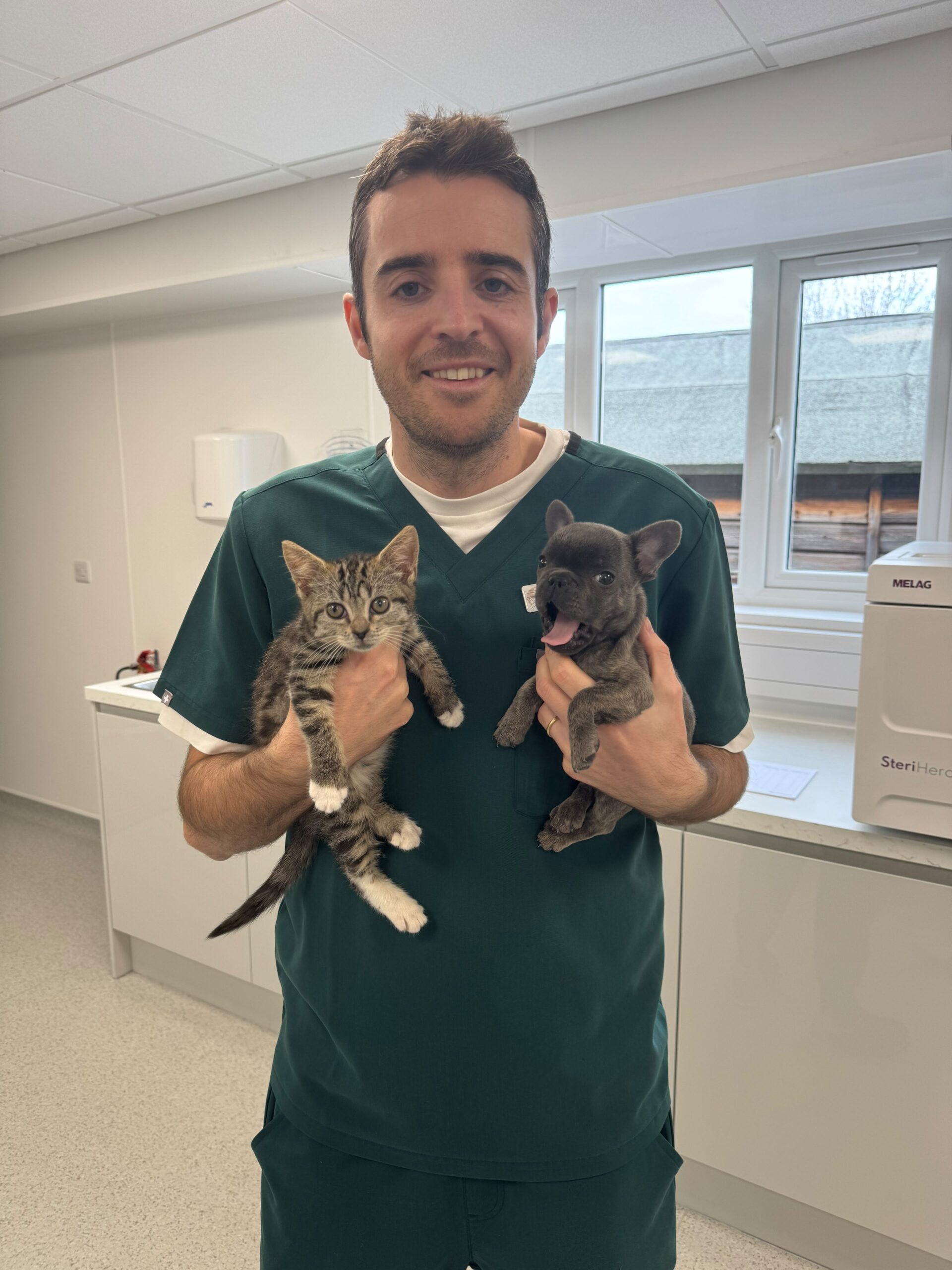 A Surrey Family Vets clinician holding a kitten and puppy